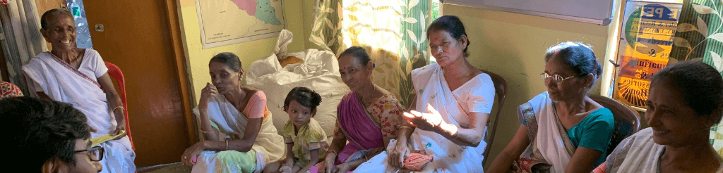 Women talking to researcher in their home