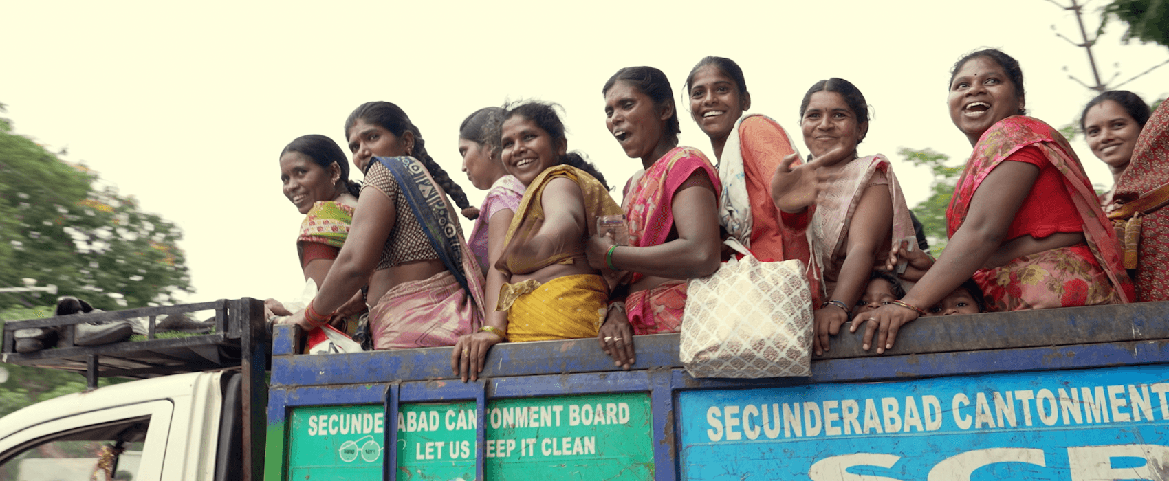 Women on the top of an open truck laughing